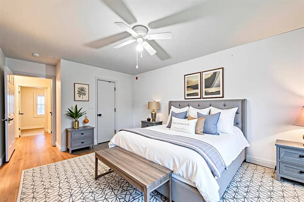 Relax and unwind in this serene, virtually staged primary suite featuring soft neutral tones, elegant wood-look flooring, and abundant natural light. The spacious layout easily accommodates a king-sized bed and additional furnishings, while the ensuite setup offers comfort and privacy. A peaceful retreat to start and end your day.