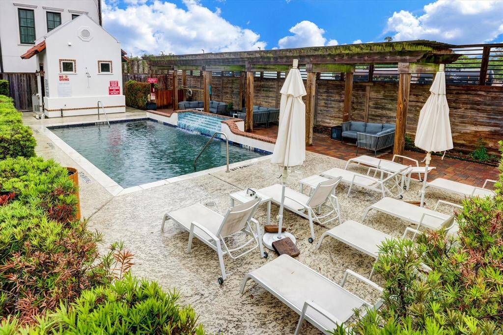 Community pool area with covered seating area, great for entertaining