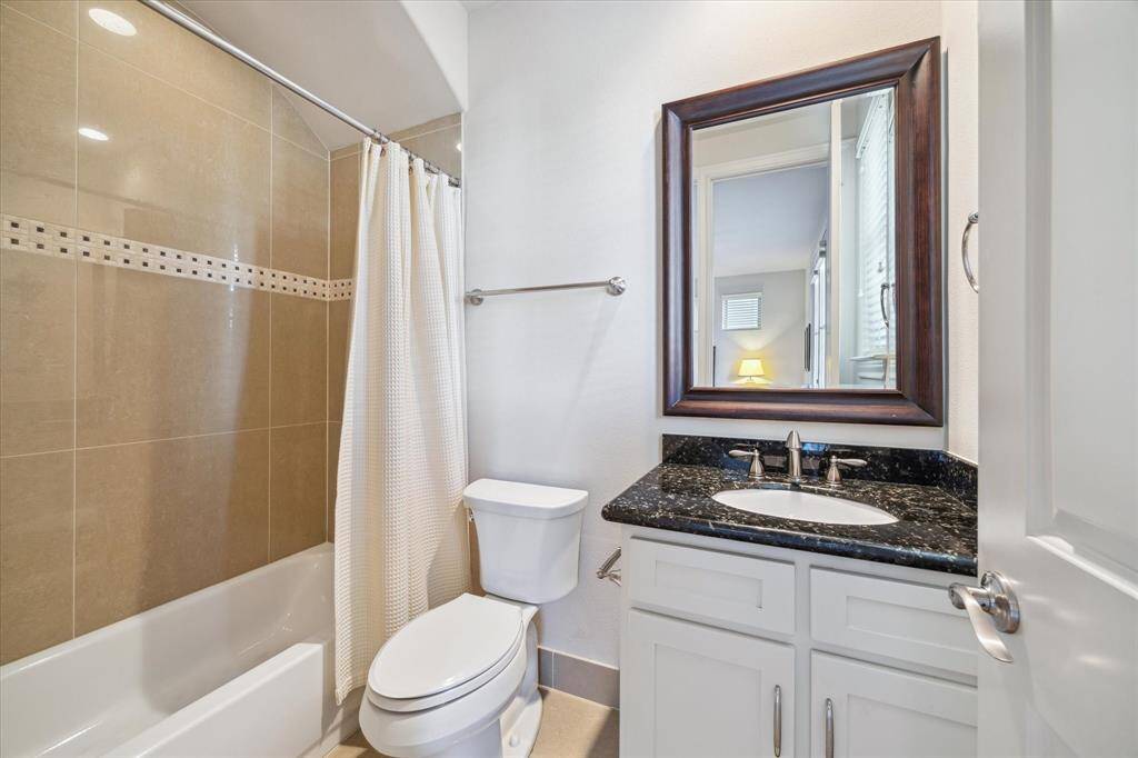 En suite secondary bath with tub/shower combo on first floor