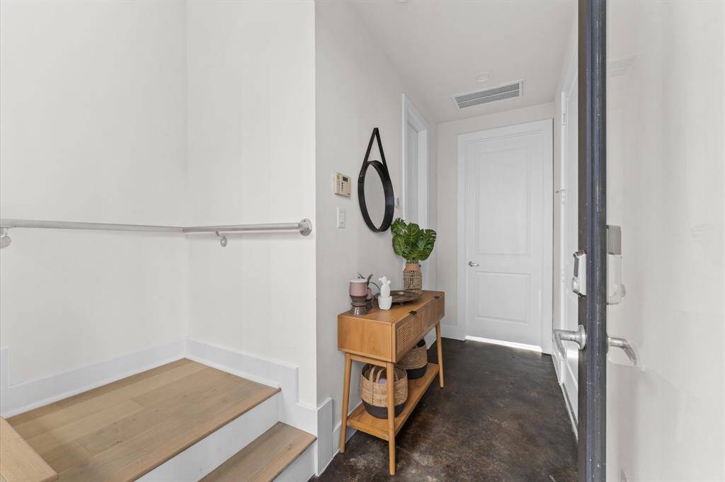 Welcoming entry with contemporary concrete floors and a clean, modern aesthetic—sets the tone for the home’s design-forward feel.