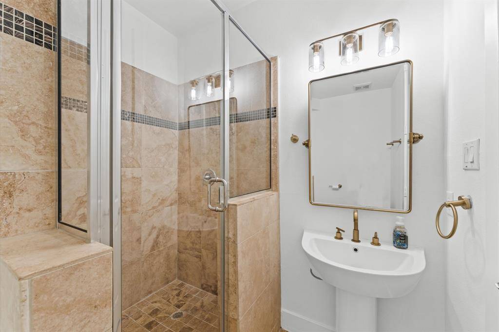 Versatile first-floor bedroom with designated bath—perfect as a private office, guest suite, or flexible work-from-home space.