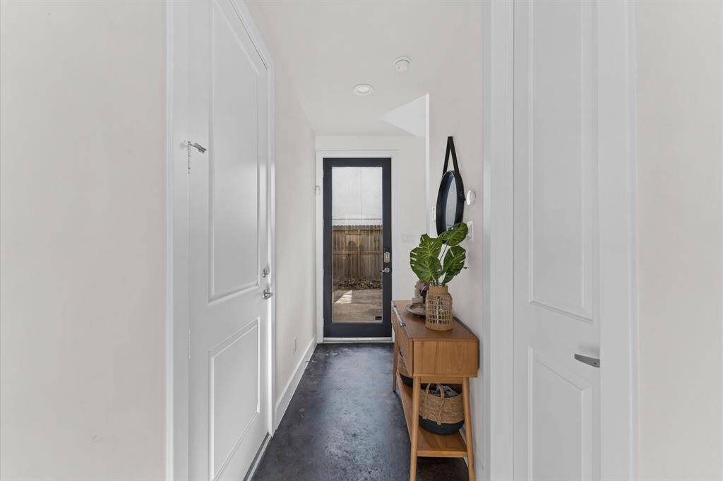 Welcoming entry with contemporary concrete floors and a clean, modern aesthetic—sets the tone for the home’s design-forward feel.