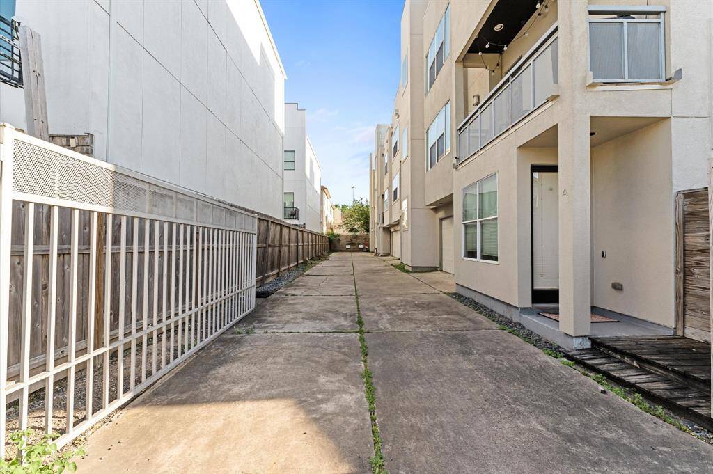 View of the shared driveway and private garage access—quiet, clean, and tucked away from the street for added privacy.