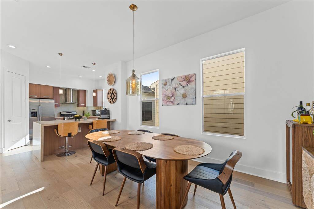 Stylish dining setup with seating for six, seamlessly connected to the kitchen and living room for a welcoming, open flow.