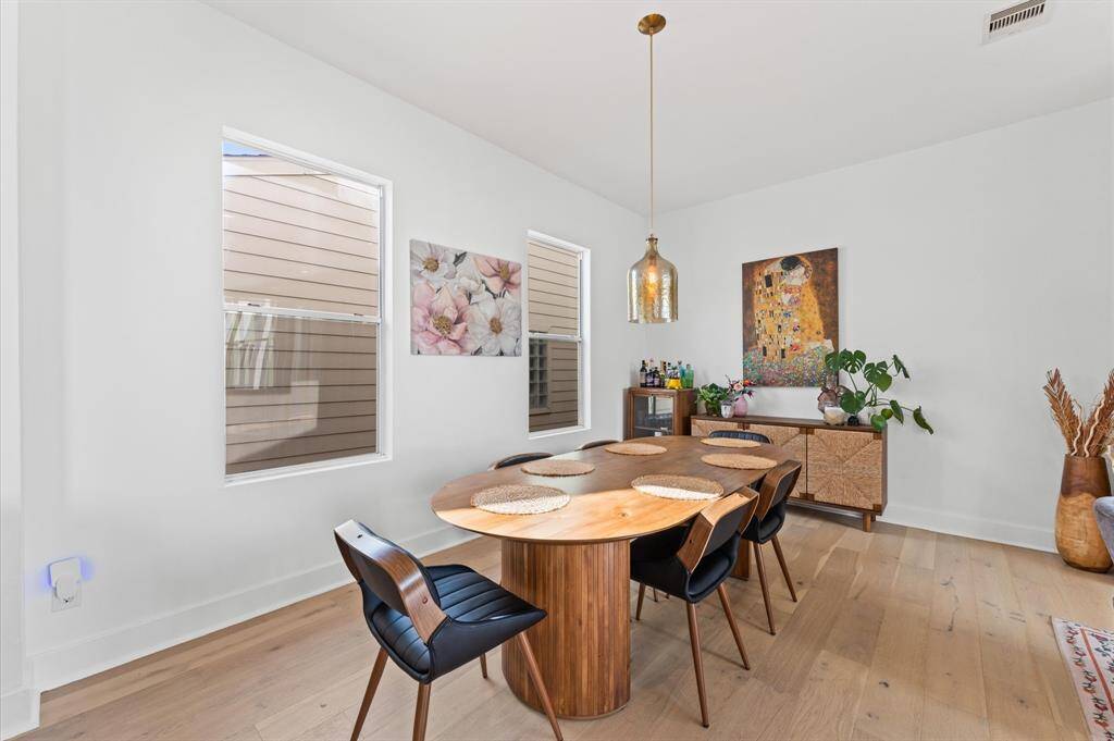 Stylish dining setup with seating for six, seamlessly connected to the kitchen and living room for a welcoming, open flow.