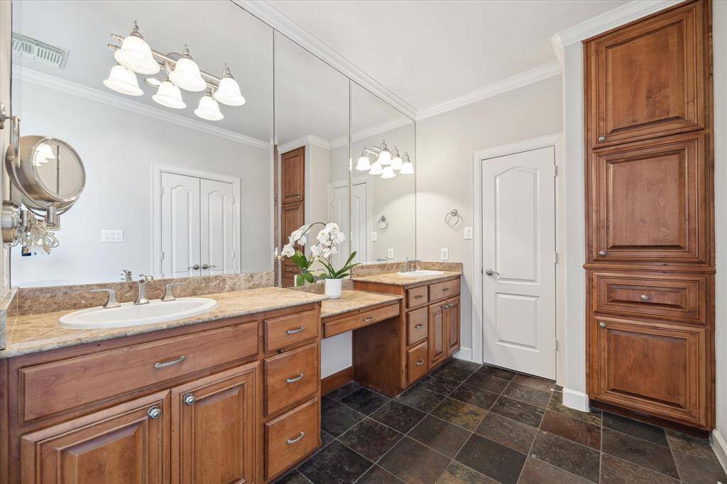 Primary bathroom with double vanities, tub and shower.