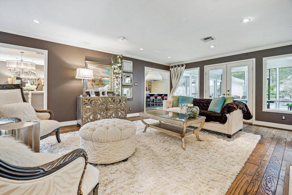 The 22' x 17' living room features variable width hardwood floors, recessed can lighting and crown moulding. The cased opening in center frame leads to the kitchen.