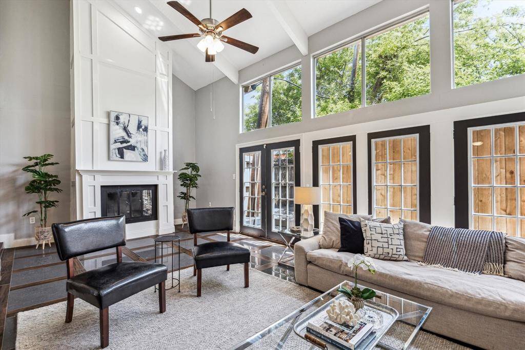 Formal living room with high ceiling, picture windows, wood tile floors and inlayed marble/wood floors.