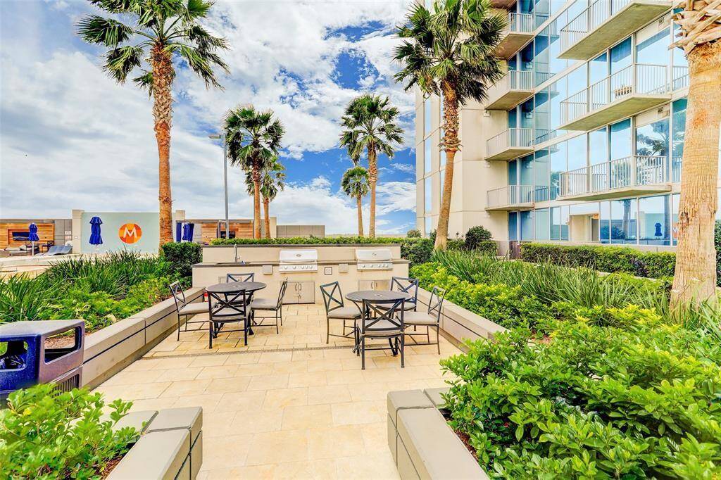 Rooftop infinity pool with private cabanas, jacuzzi, gas grills, TVs, social lounge, and fire pits.