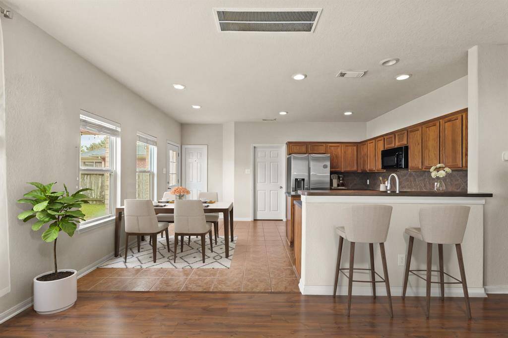 Virtually Staged: Enjoy a meal with your family in this lovely dining area, flowing seamlessly into the living room to make a great entertaining space!