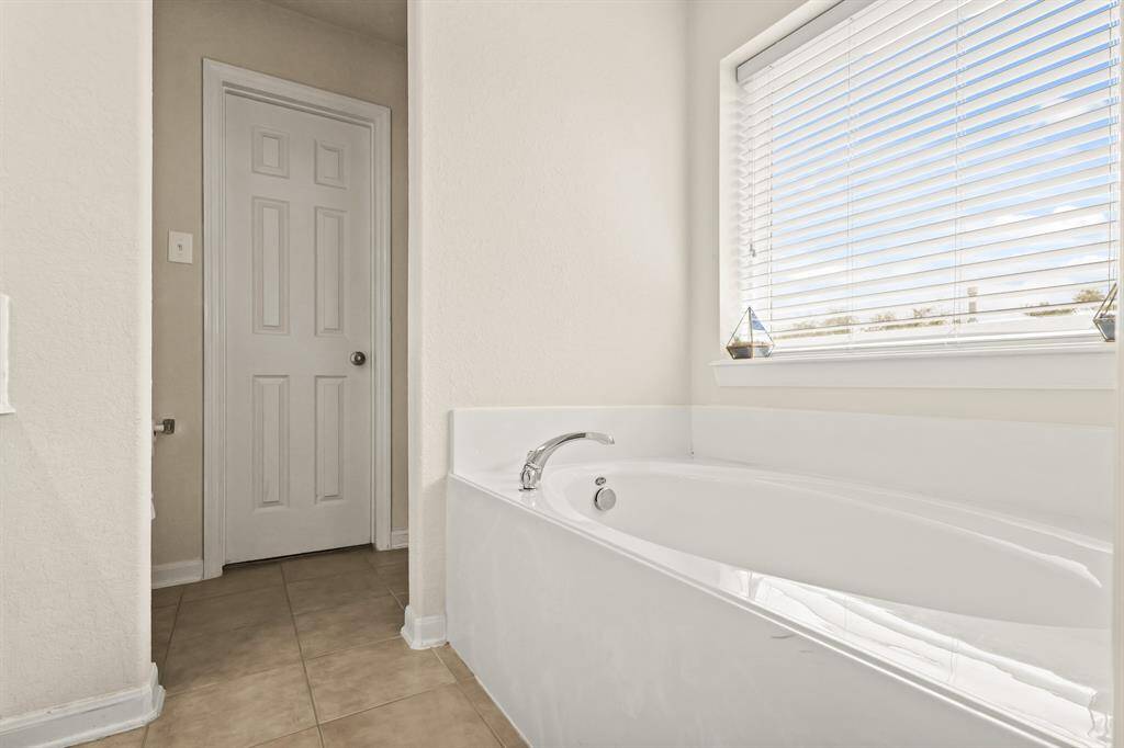 This separate soaking tub with a large window will be your new favorite place to sit, drink a glass of wine and relax after a long day!
