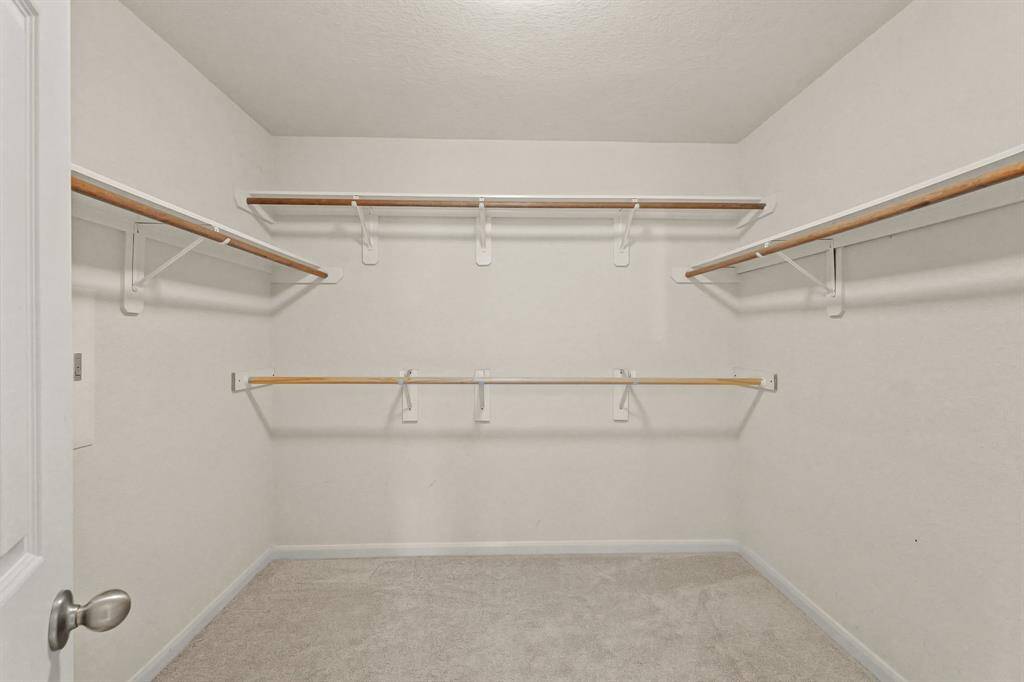 Spacious walk-in closet in the primary bathroom.