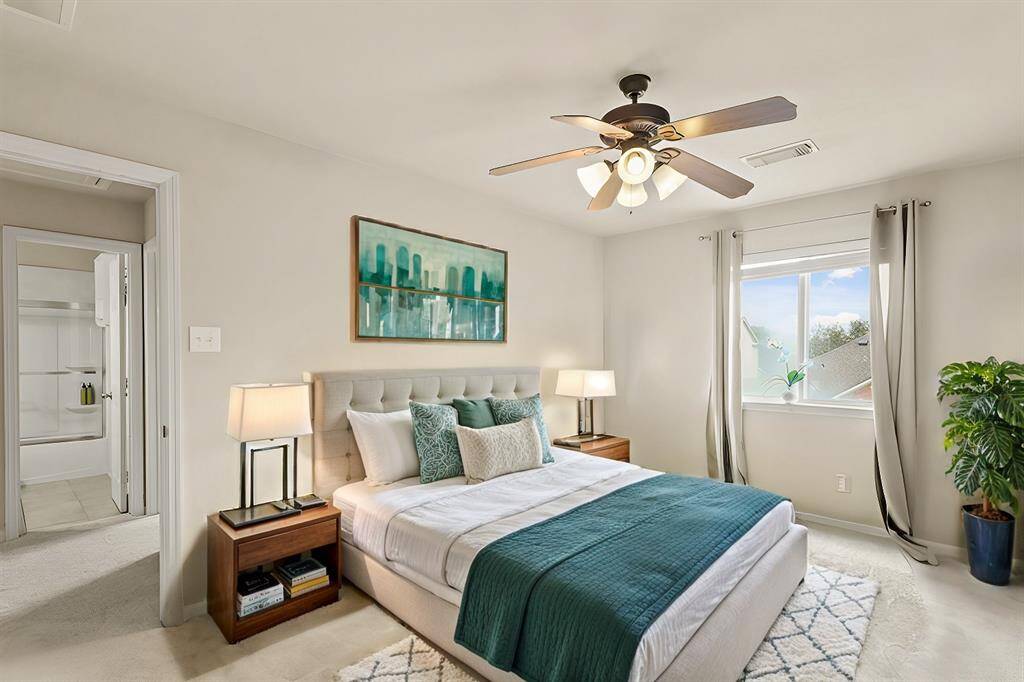 Virtually Staged: Secondary Bedroom featuring carpet floors, a ceiling fan, and a large window.