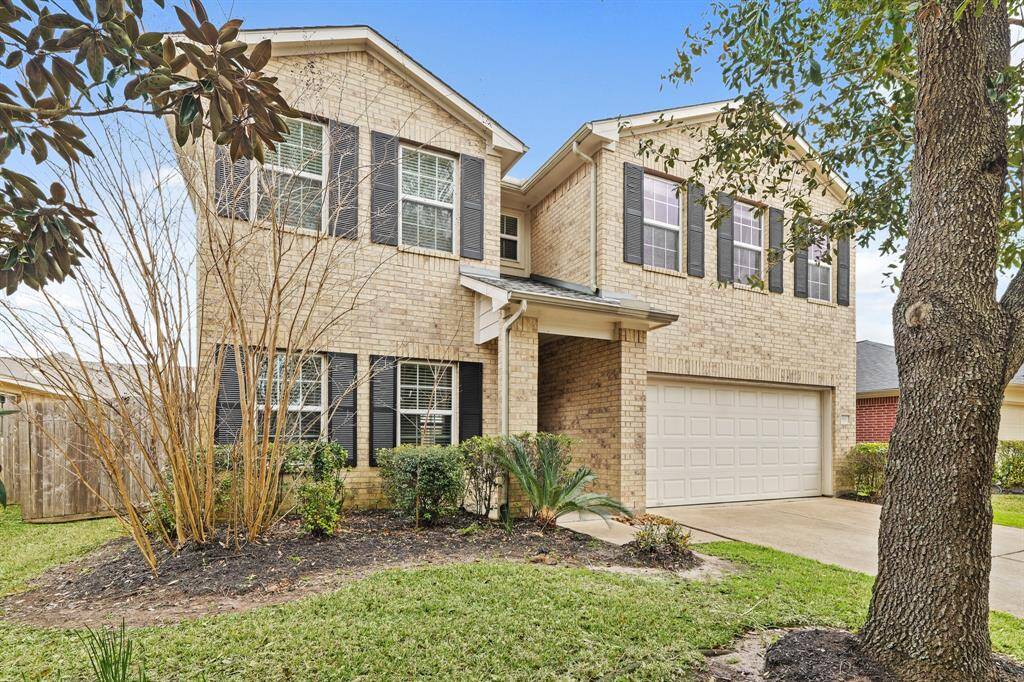 A beautiful array of windows allow natural light through the front of the home in this grand two story home.