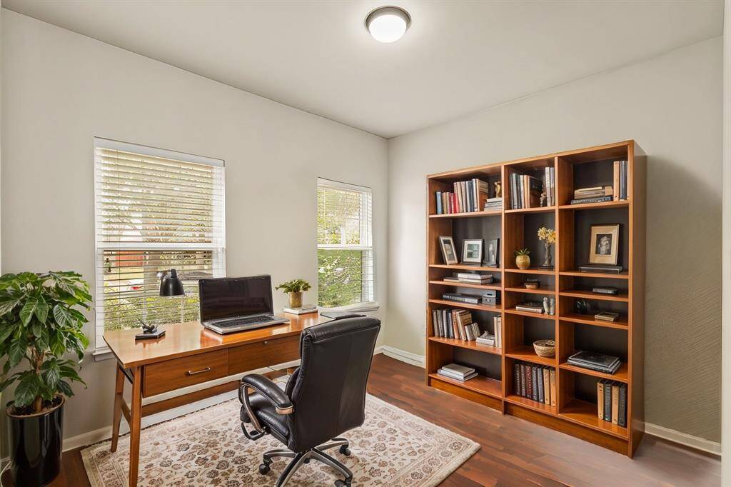 Virtually Staged: Nestled quietly in this immaculate home is the stunning home office! Featuring dark stained laminate floors, and large windows with privacy blinds.