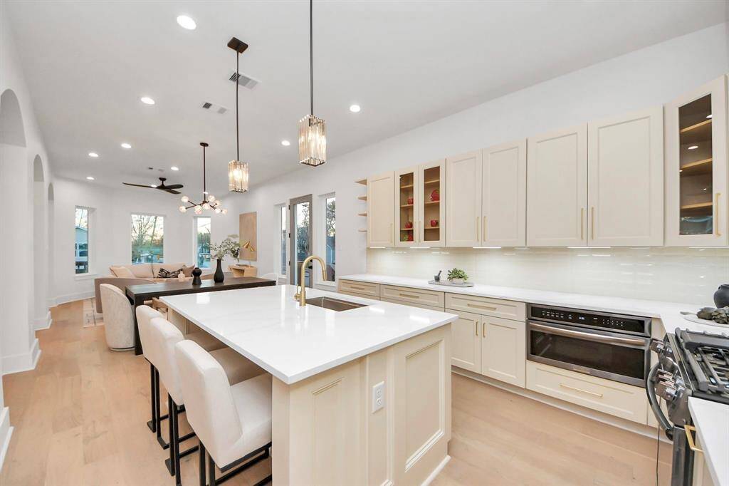 The kitchen features an upgraded black stainless built-in microwave with a convenient drop-down door, making it easier to access your food.