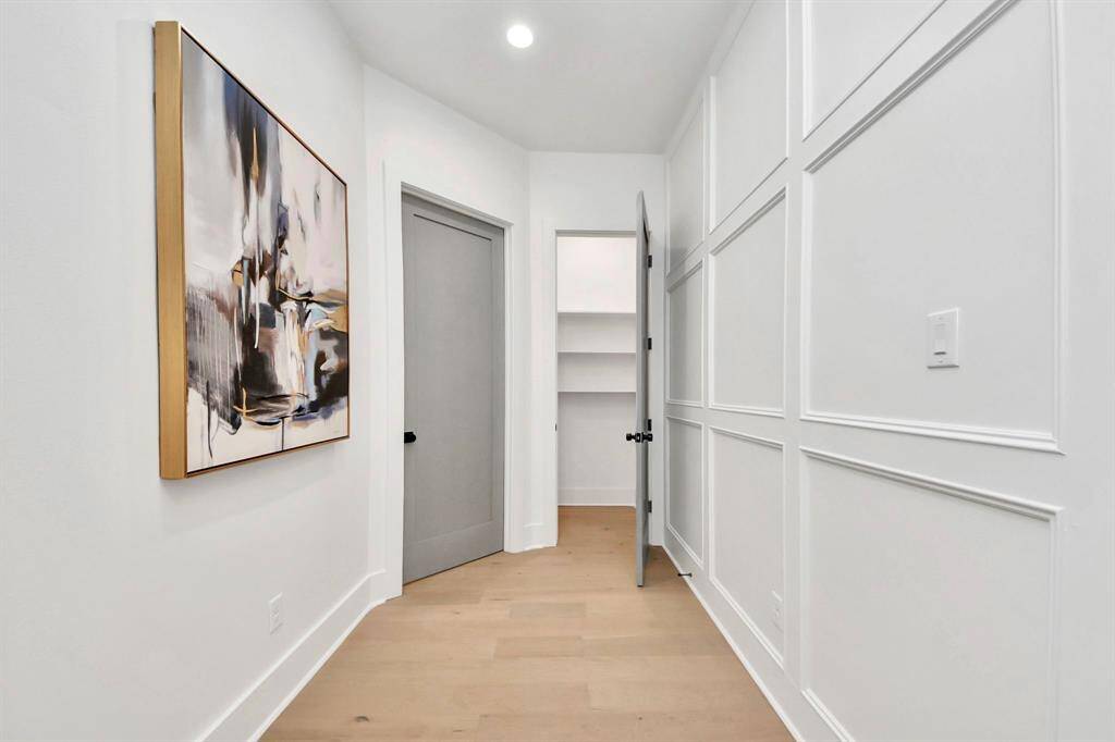 Upstairs, the hallway features an accent wall bringing you to the 2nd + 3rd bedrooms.