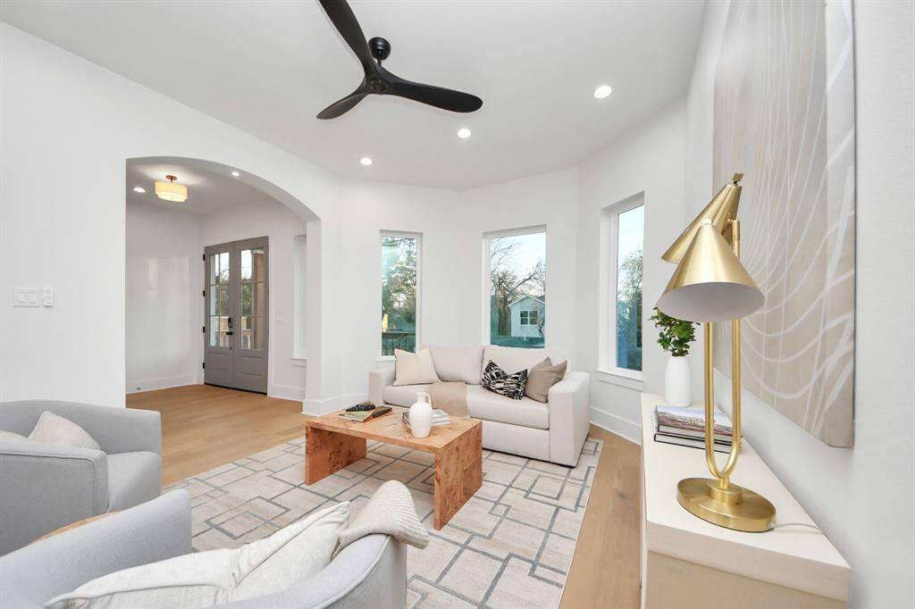 Step in and unwind in your living room, passing through an archway illuminated by 2-inch lights, drawing you into the vibrant space.