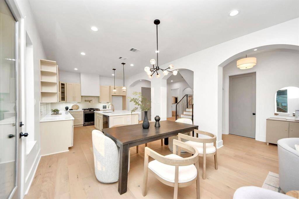 The living room flows seamlessly into the dining room, creating an open, connected space perfect for entertaining or everyday living. The doors to your right lead you outside to the side yard.