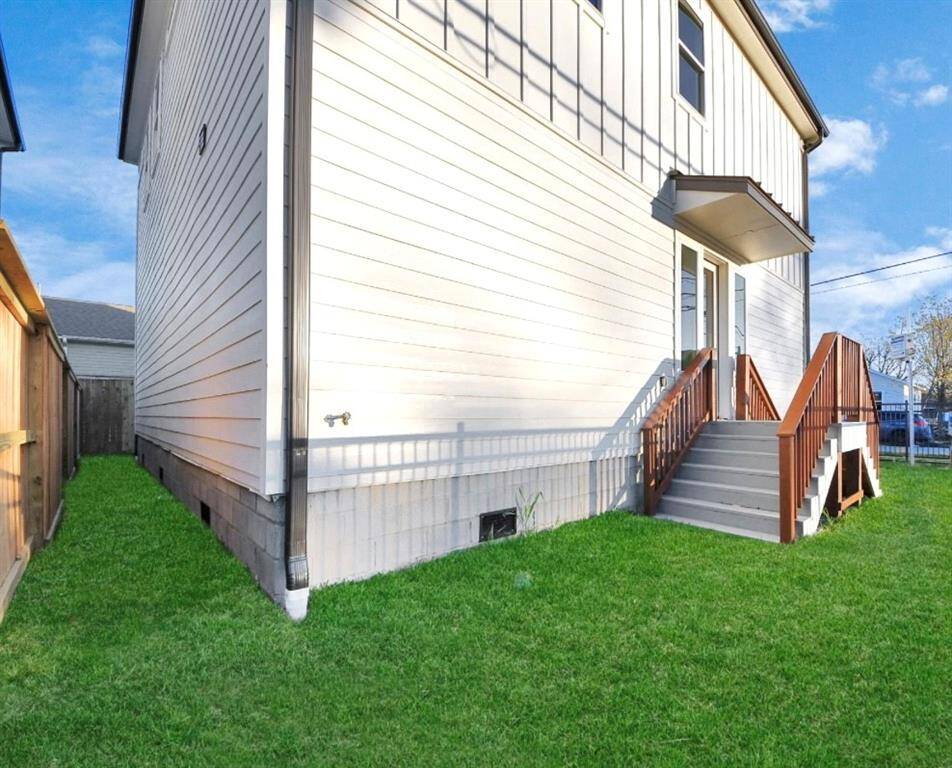 Cedar-stained dual landing staircase with wide steps, inviting you to explore both sides of your side yard.