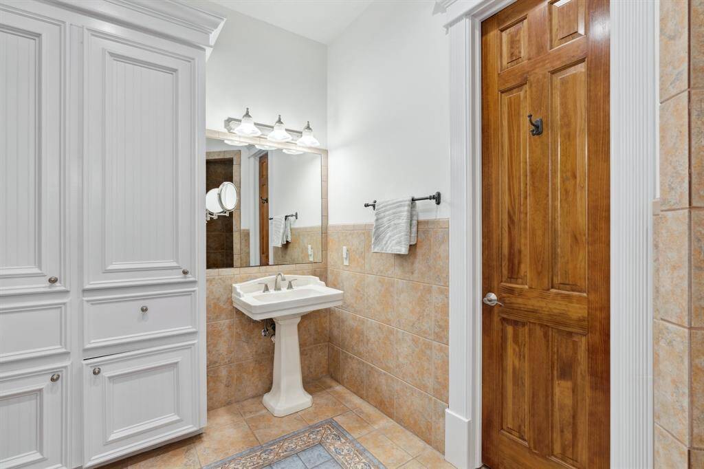 Additional view of the primary bath showcasing the ample storage space.