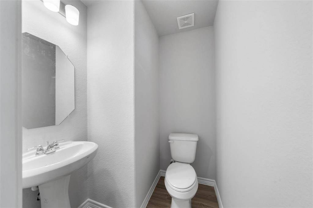 Downstairs half bath adds extra convenience.