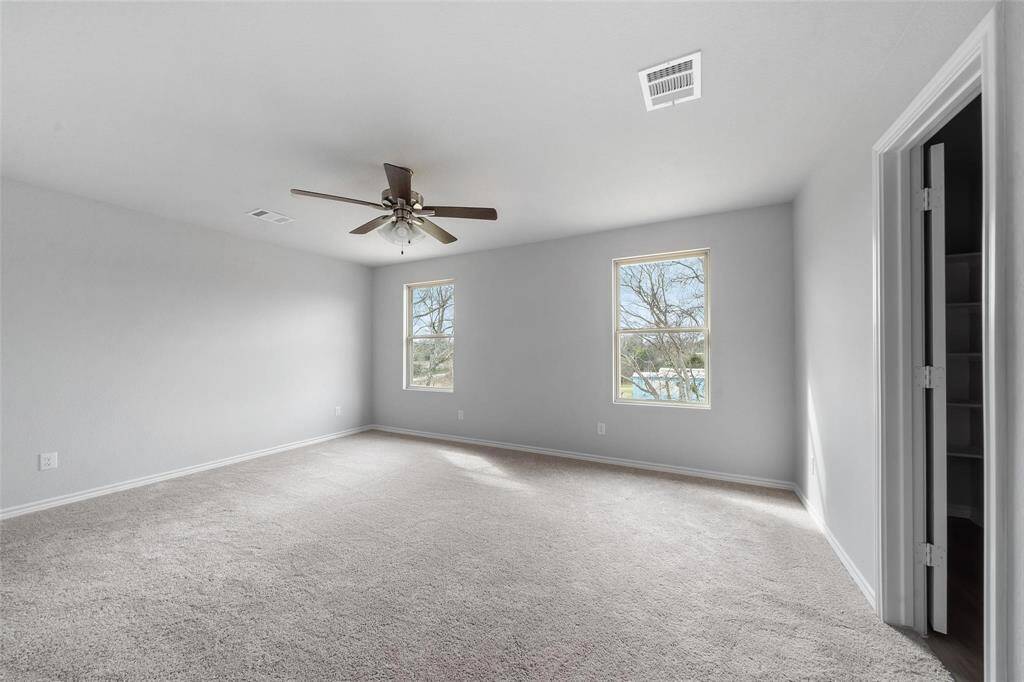 The large primary suite offers plenty of room and beautiful natural lighting.