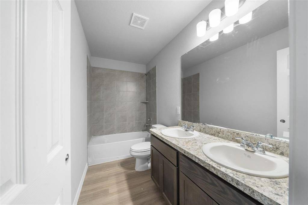 The secondary bathroom features a stylish double vanity and a beautifully finished shower.