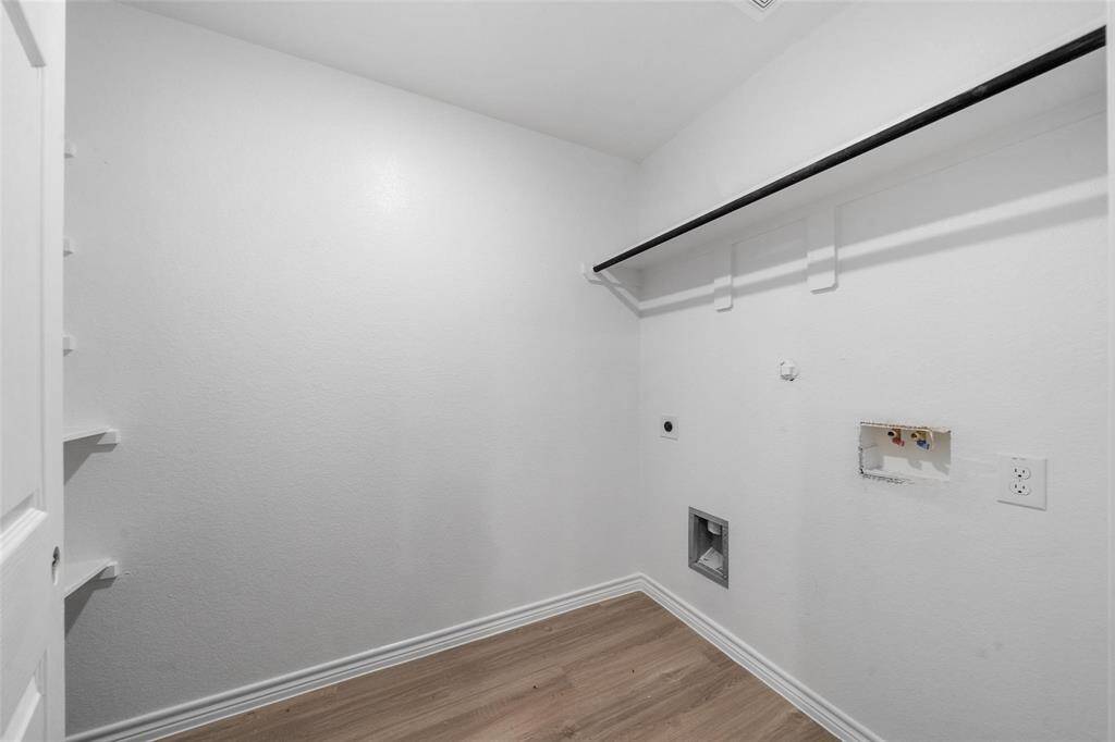 The utility room offers ample space and a convenient hanging area for added functionality.