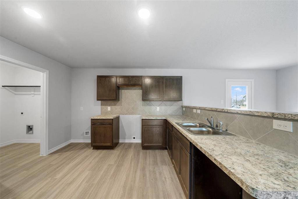 Generous counter space paired with warm brown cabinetry.