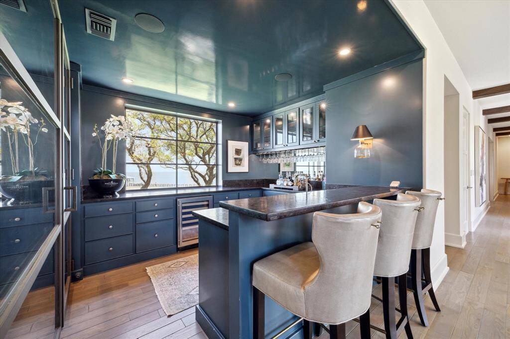 A premier wet bar with accompanying climate-controlled wine room ensures you and your guests are well-provisioned.