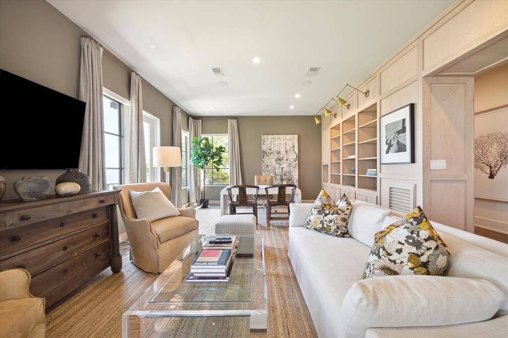 Elegant and airy library offers a quiet place to work or reflect. Each window provides a spectacular view with access to a balcony overlooking the pool and bay.