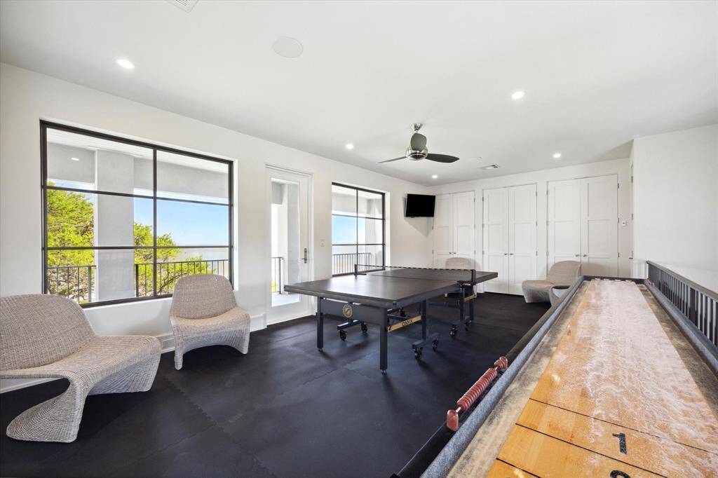 Upstairs in the northern wing of the home is a sizable game room with a spacious balcony! The elevator provides easy access to this floor, or take the lovely stairs.