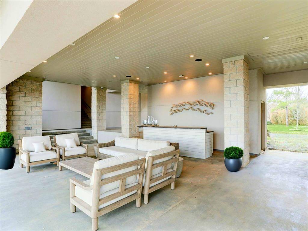 This poolside summer kitchen is located under a breezeway with access to a convenient locker room - pool parties have never been more ideal!