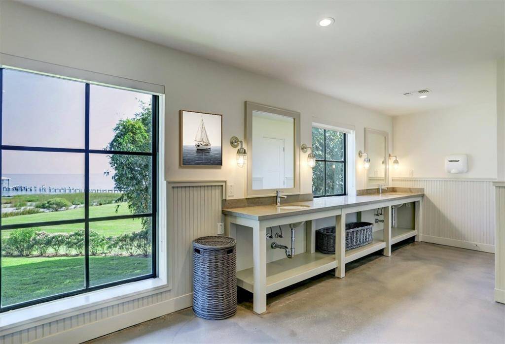 Conveniently located by the pool, this locker room is complete with a shower, 10 lockers, double vanity, and 2 bathroom stalls.