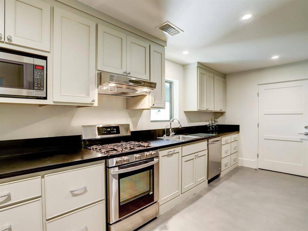 The catering kitchen located by the outdoor summer kitchen - ideal for hosting events. The space also includes a washer/dryer and two large storage closets.