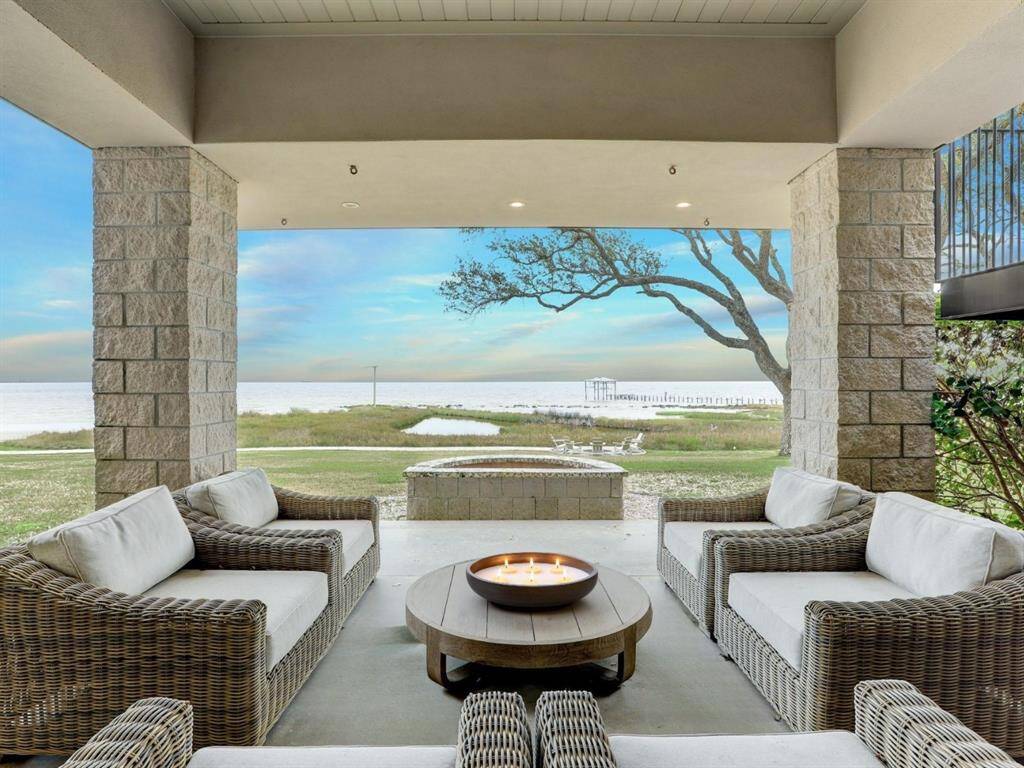 Yet another covered area to enjoy the sea breeze. Lounge by a gas fire pit on cool days. With so much beauty surrounding you and so many activities for the whole family, this bay house is a destination everyone will love.