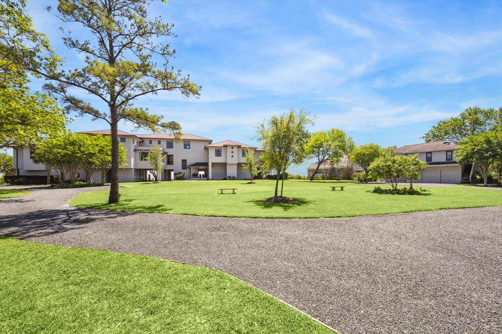 The expansive grounds of your 2-acre, resort-like bay home are lush and manicured.