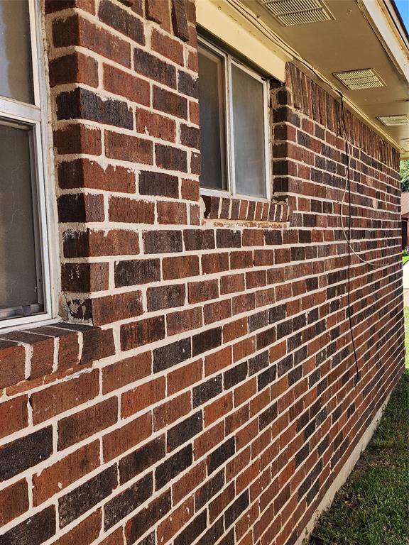 Exterior brick veneer on both side of house