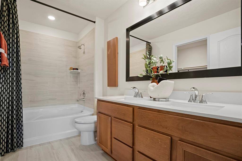 This large primary bath is spacious enough to share! With separate vanities, plentiful cabinet and counter space, you are sure to have private area while sharing this bathroom! Also featuring this gorgeous Moroccan Concrete Hexagon porcelain tile flooring!