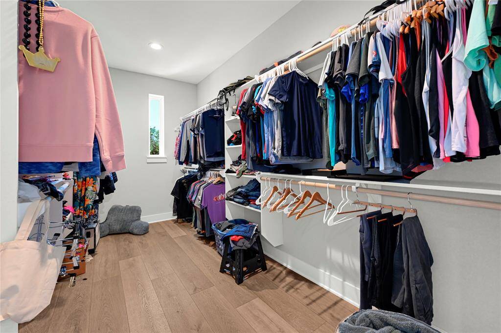Large primary closet with plenty of storage
