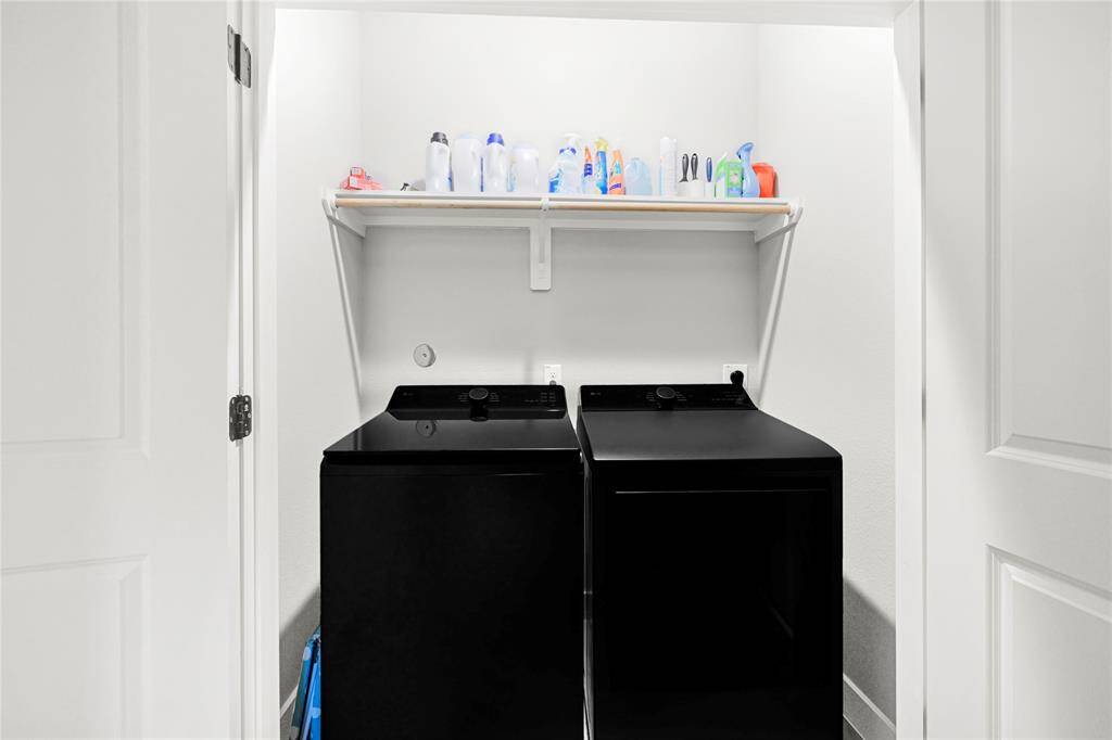 Laundry room w/ storage.  Washer and dryer stay