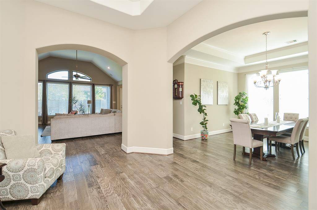 Sweeping arched doorways invite and designate room purposes, like the bright formal dining area, right and amazing living area, left.