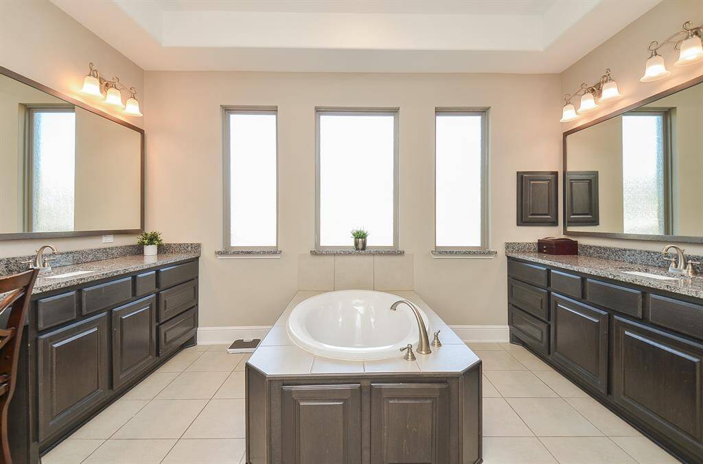 Balance is always a good thing in life, and especially in your primary ensuite bath. Dual/separate counters offer lots of space, with great storage below; delicate lighting above, and a trio of frosted glass windows providing privacy for your long, languishing soak in this amazing bathtub!