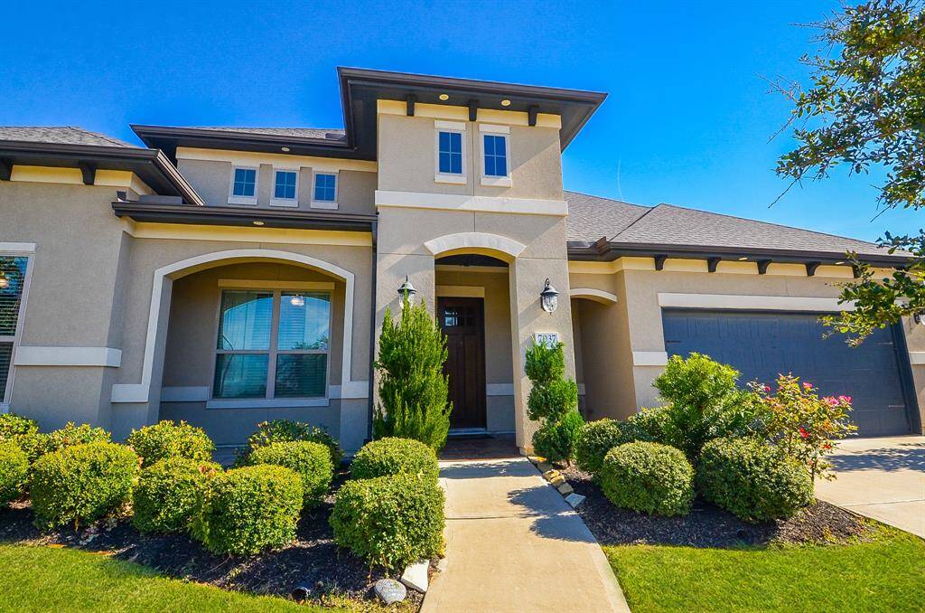 The majestic covered front entry shares a cozy front porch, lined with native greenery as Mother Nature's welcome mat.