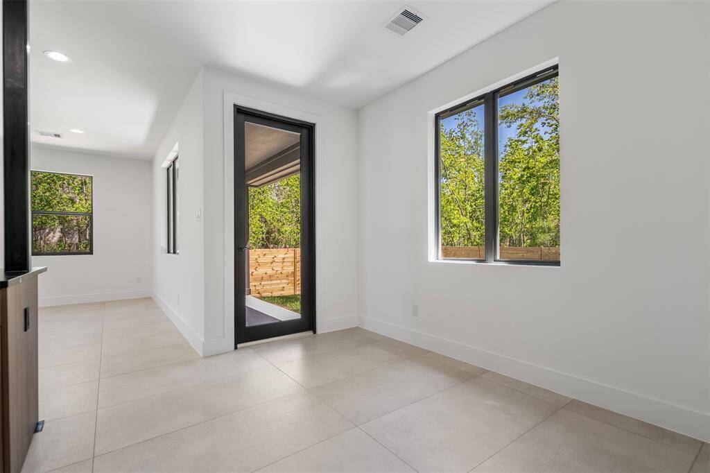 Versatile space with glass door leading to the covered patio and backyard—ideal for indoor-outdoor living.