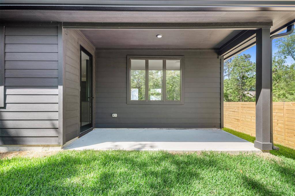 Covered back patio with recessed lighting and room for outdoor furniture—perfect for relaxing or entertaining while enjoying the backyard view.