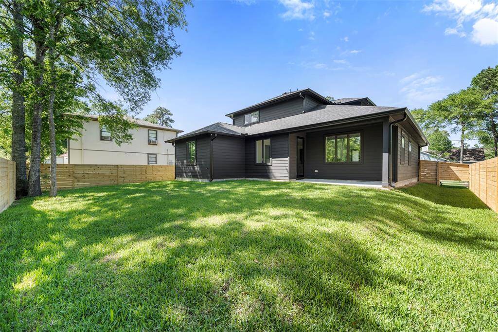 Expansive fully fenced backyard offering plenty of room for kids, pets, or future landscaping ideas, surrounded by mature trees for privacy.