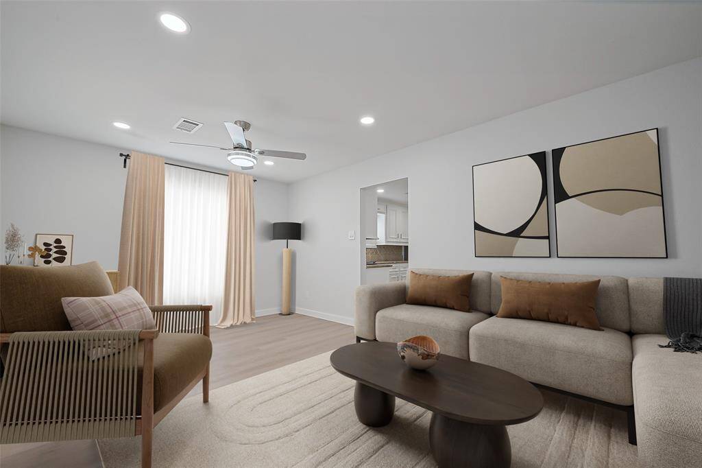 *virtually staged* From the living room, enjoy a glimpse of the kitchen, with easy access through the open doorway, creating a seamless flow between spaces.
