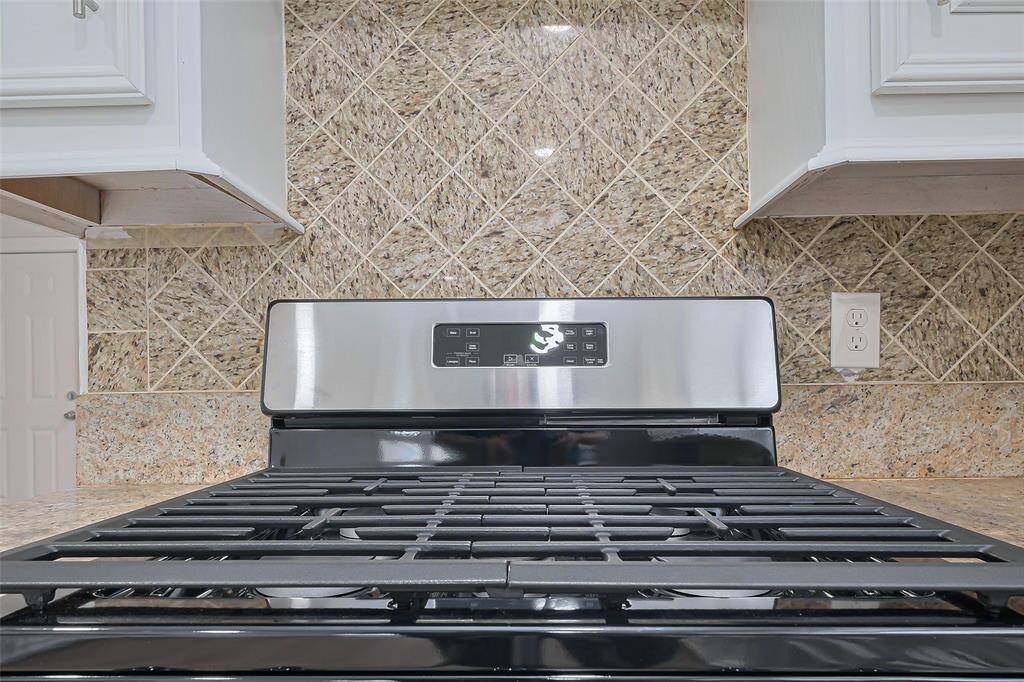 A closer look at the kitchen’s new tile backsplash reveals its intricate texture and pattern, adding visual interest while complementing the overall design.